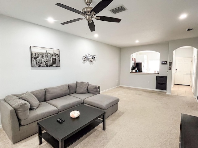 living room featuring ceiling fan and light colored carpet