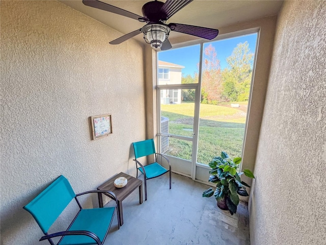 sunroom / solarium with a wealth of natural light and ceiling fan