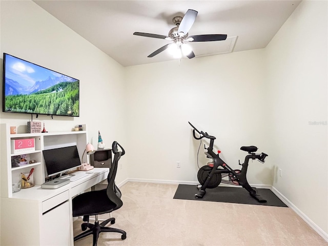 carpeted home office featuring ceiling fan