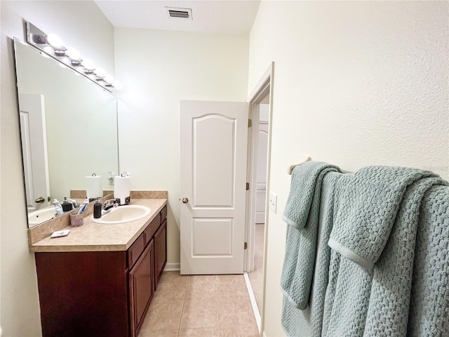 bathroom with tile patterned flooring and vanity