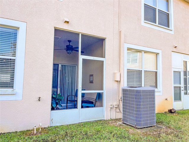 doorway to property with central air condition unit and ceiling fan