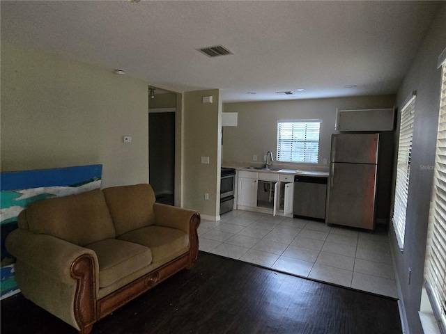 tiled living room featuring sink