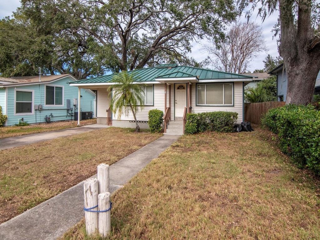 ranch-style home featuring a front yard and a carport