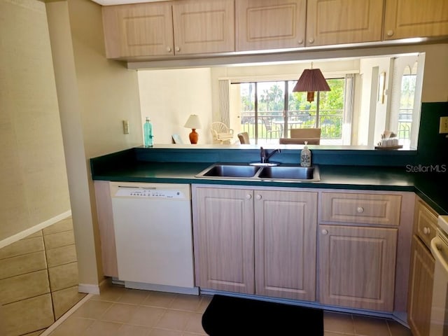 kitchen with dishwasher, stove, light tile patterned floors, and sink