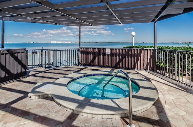 view of patio / terrace with a community hot tub and a water view