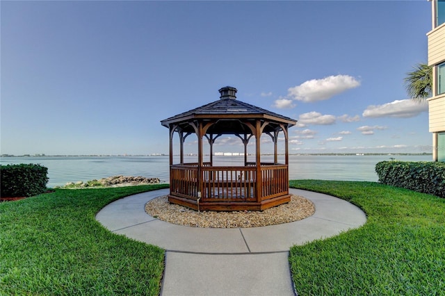 view of property's community featuring a gazebo, a water view, and a yard