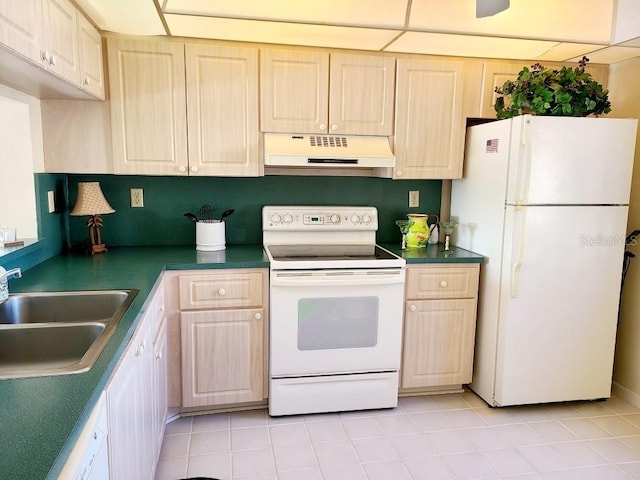 kitchen featuring light tile patterned floors, white appliances, and sink