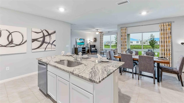 kitchen with white cabinets, ceiling fan, a kitchen island with sink, sink, and dishwasher