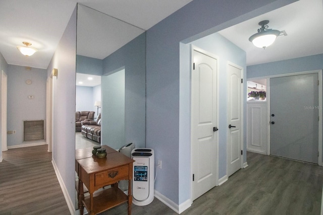 corridor featuring dark wood-type flooring and heating unit