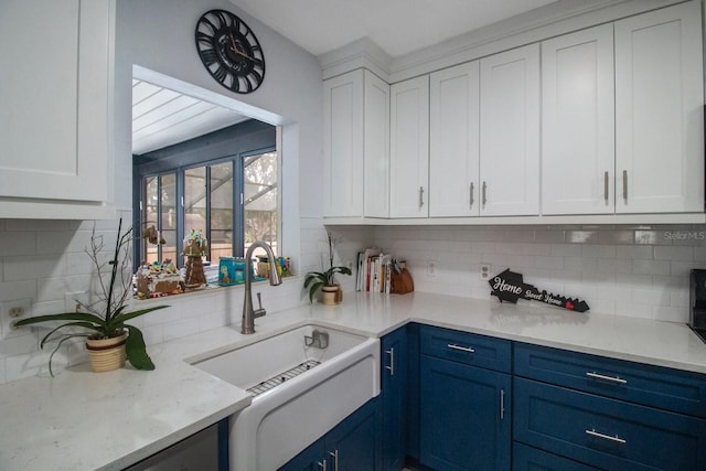 kitchen with blue cabinetry, sink, and white cabinets