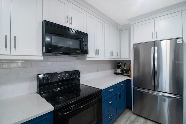 kitchen featuring decorative backsplash, black appliances, white cabinets, and blue cabinets