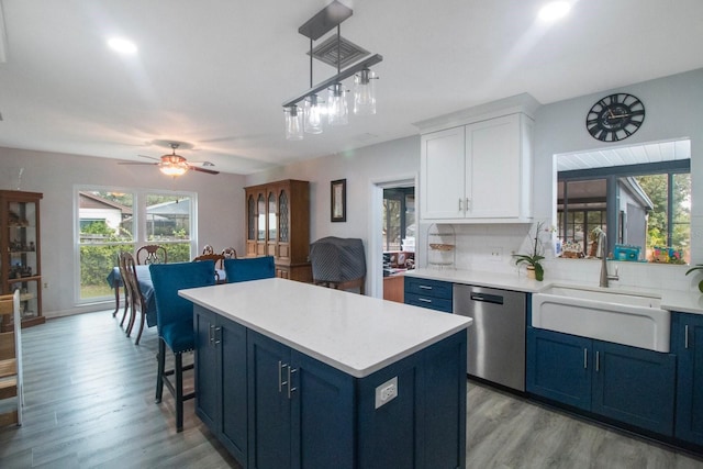 kitchen featuring sink, blue cabinetry, ceiling fan, white cabinetry, and stainless steel dishwasher