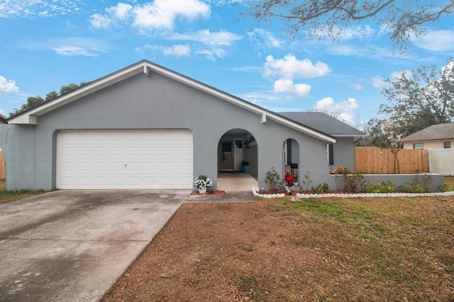 ranch-style house with a garage and a front lawn