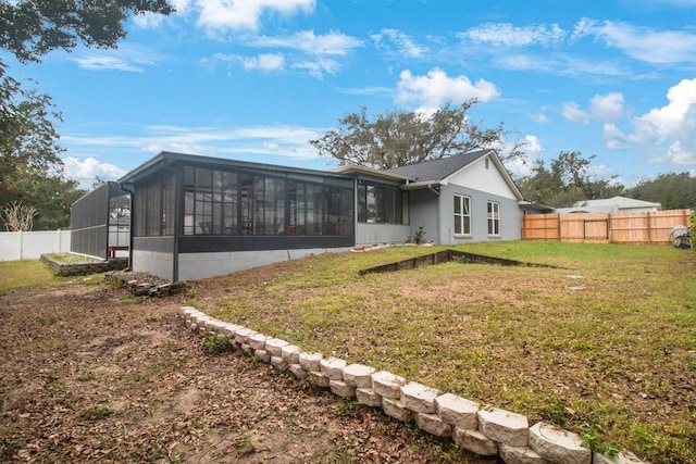 rear view of house featuring a lawn