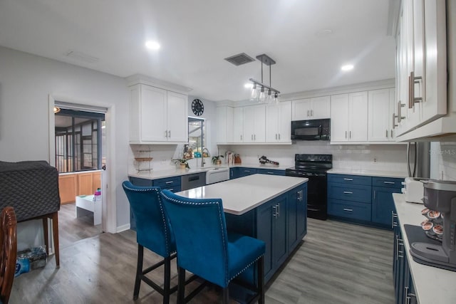 kitchen with blue cabinetry, a center island, black appliances, white cabinets, and decorative light fixtures