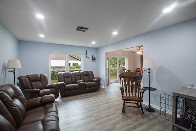 living room with hardwood / wood-style flooring and ceiling fan