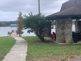 exterior space with a water view and a lawn