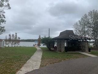 view of side of property with a water view and a lawn