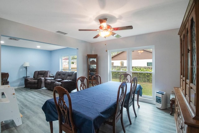 dining area with ceiling fan, a healthy amount of sunlight, and light wood-type flooring