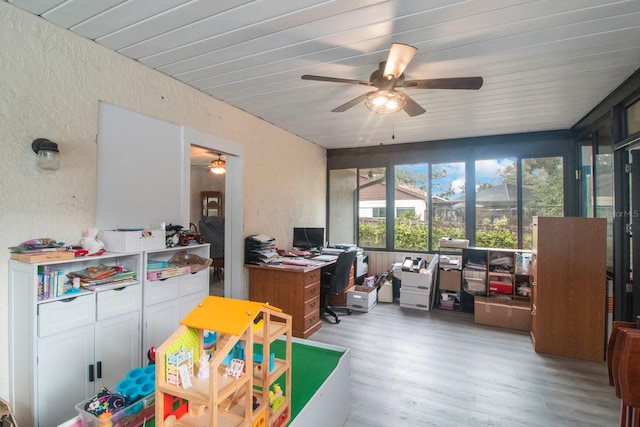 rec room with ceiling fan and light hardwood / wood-style floors