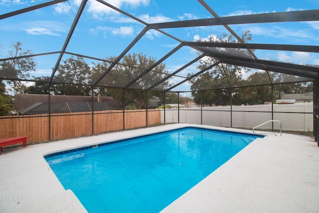 view of swimming pool with a lanai and a patio area