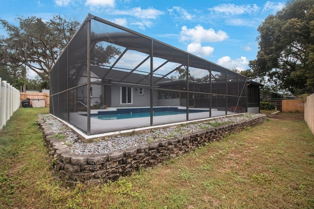 exterior space with a fenced in pool, a lawn, and glass enclosure