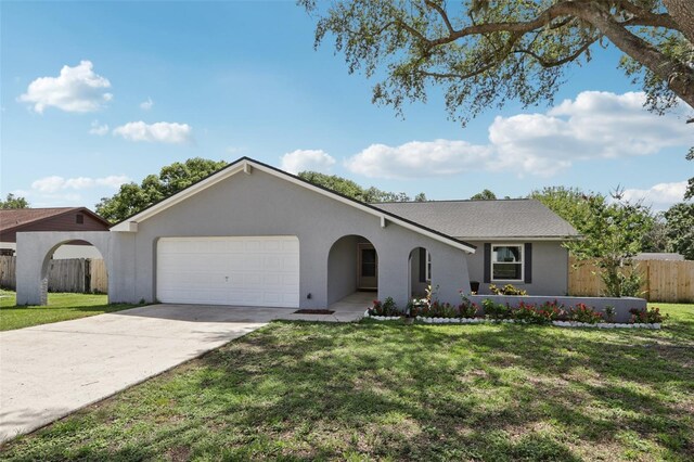 1009 Black Knight Dr, Valrico, FL 33594 - ranch-style house featuring a garage, driveway, and stucco siding