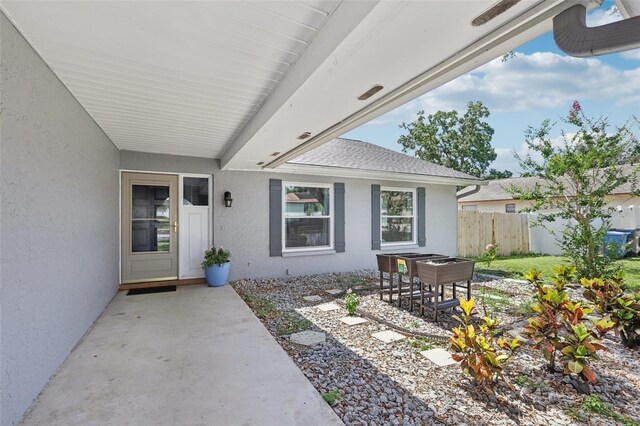 1009 Black Knight Dr, Valrico, FL 33594 - property entrance with stucco siding and a patio area