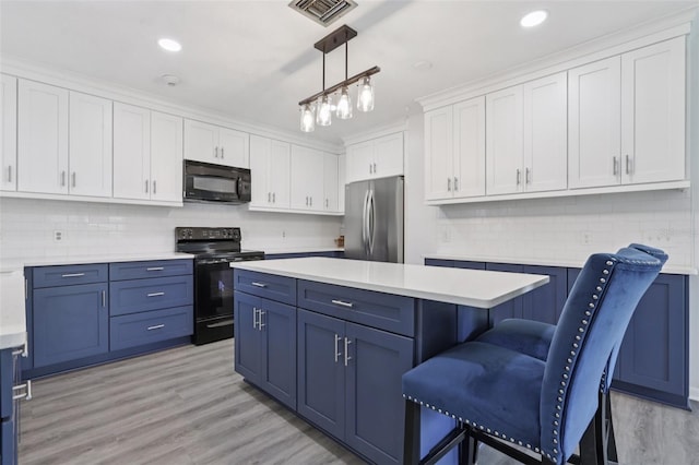 1009 Black Knight Dr, Valrico, FL 33594 - kitchen featuring black appliances, blue cabinets, white cabinetry, light countertops, and recessed lighting