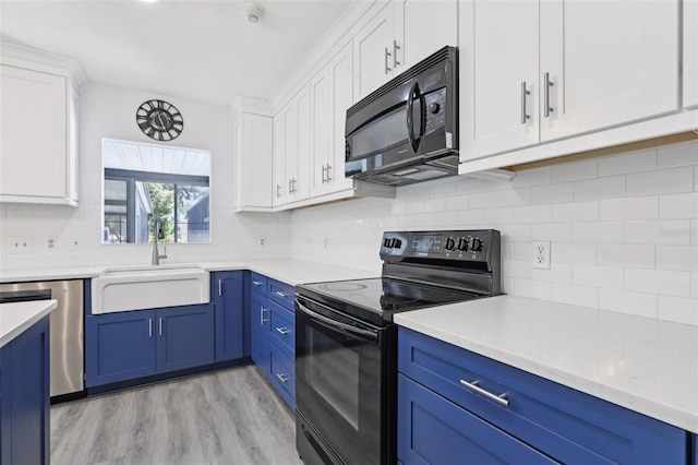 1009 Black Knight Dr, Valrico, FL 33594 - kitchen with black appliances, blue cabinetry, and white cabinetry