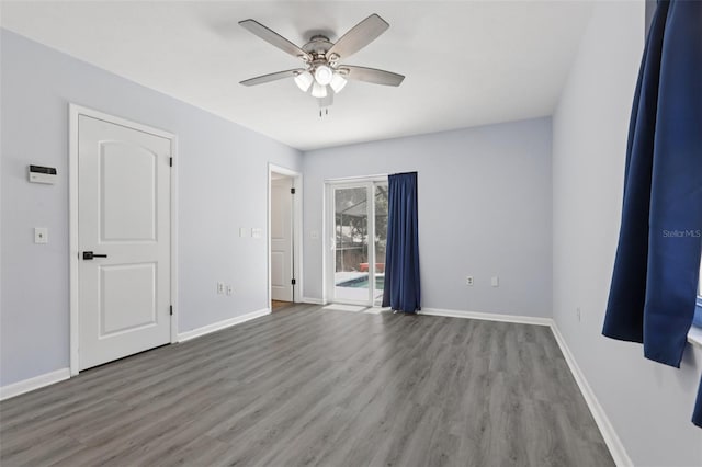 1009 Black Knight Dr, Valrico, FL 33594 - unfurnished bedroom featuring wood finished floors, access to exterior, and ceiling fan