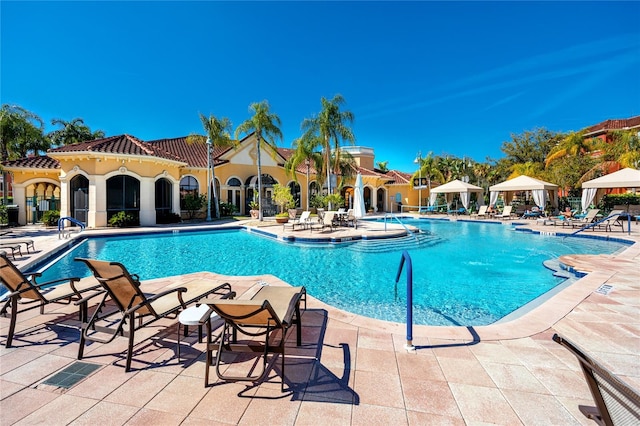 view of swimming pool with a gazebo and a patio area