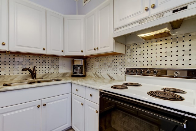 kitchen with sink, light stone counters, white range with electric stovetop, decorative backsplash, and white cabinets