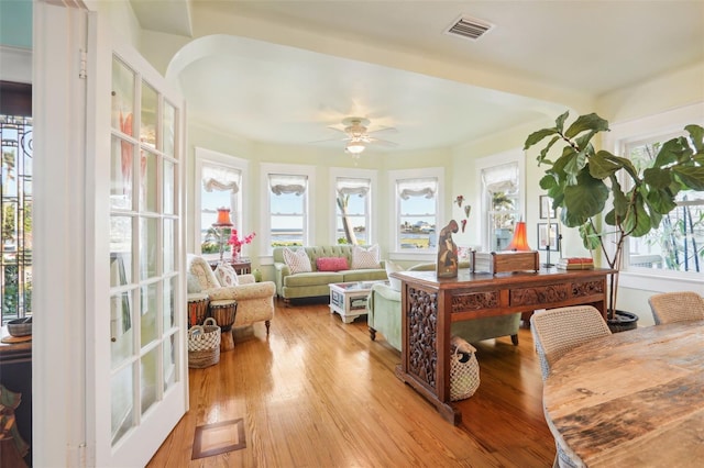 sunroom / solarium featuring ceiling fan