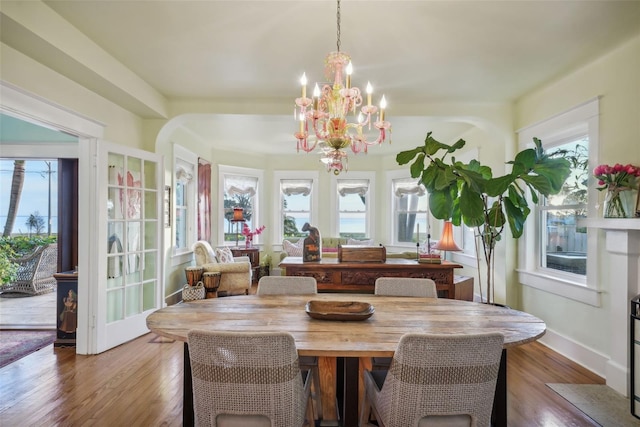 dining space featuring hardwood / wood-style flooring and a chandelier