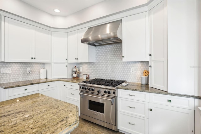 kitchen with white cabinets, exhaust hood, and stainless steel stove