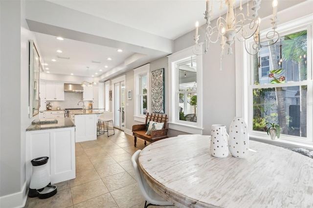 tiled dining room featuring a notable chandelier