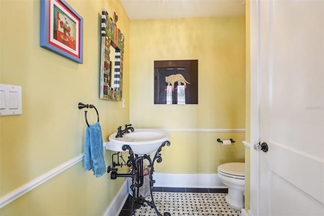 bathroom with tile patterned floors and toilet