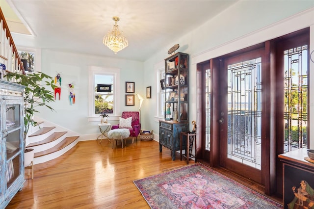 entryway featuring hardwood / wood-style flooring and a notable chandelier