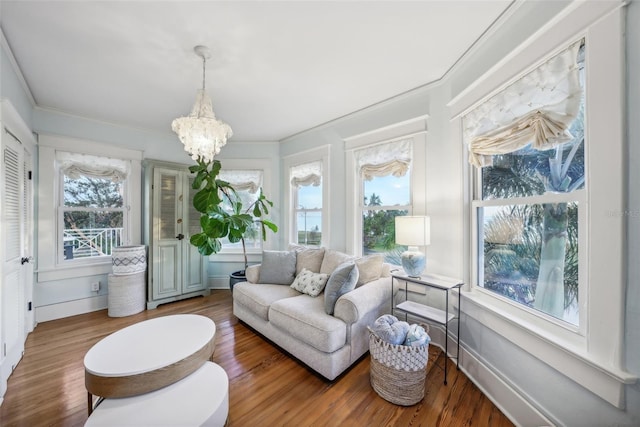 sunroom / solarium with a wealth of natural light and an inviting chandelier