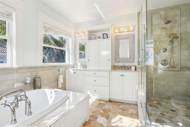 bathroom featuring shower with separate bathtub, plenty of natural light, and vanity