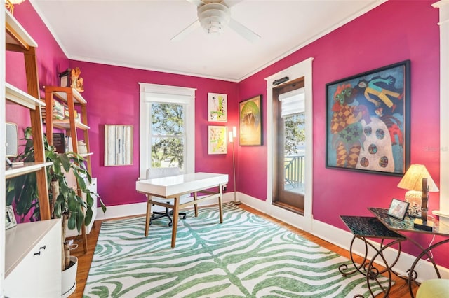 office space featuring crown molding, ceiling fan, hardwood / wood-style flooring, and a healthy amount of sunlight