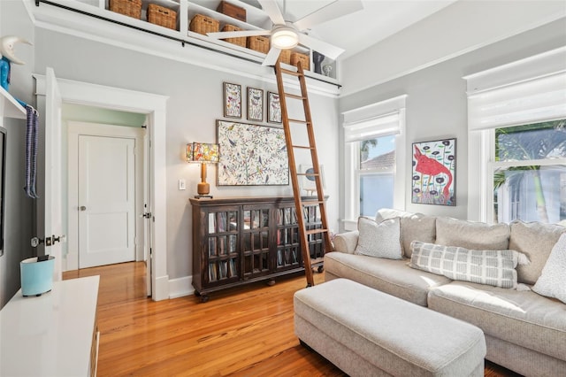 living room with wood-type flooring and ceiling fan