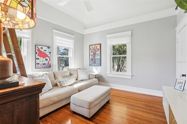 living room with hardwood / wood-style flooring, vaulted ceiling, and a healthy amount of sunlight