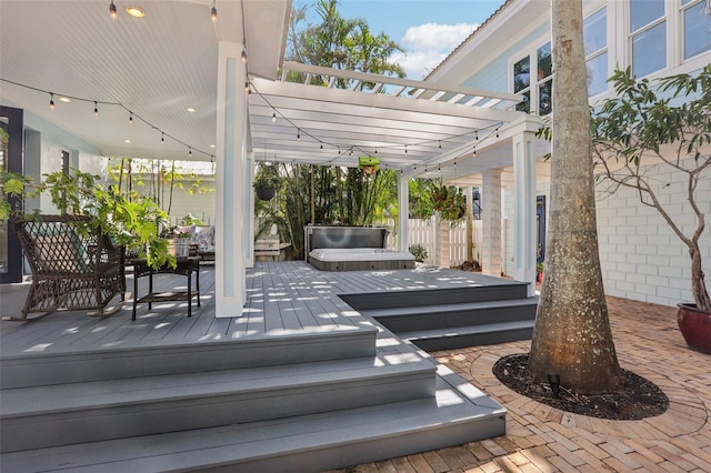 view of patio featuring a pergola, a deck, and a jacuzzi