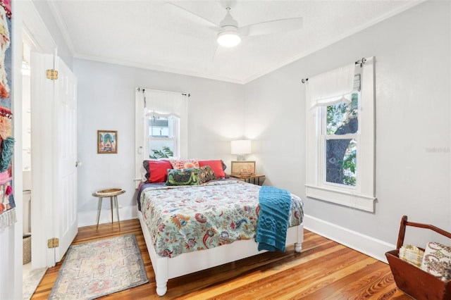 bedroom with crown molding, ceiling fan, and light wood-type flooring