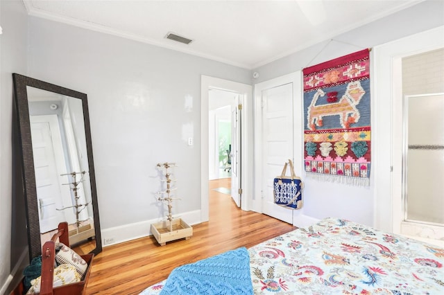 bedroom featuring crown molding and hardwood / wood-style flooring