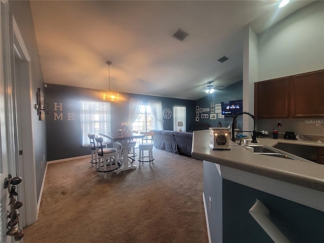 kitchen with carpet flooring, ceiling fan, sink, and vaulted ceiling