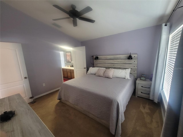 bedroom with carpet, ceiling fan, connected bathroom, and vaulted ceiling