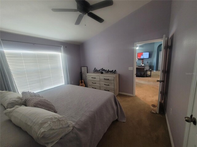 bedroom with carpet, vaulted ceiling, and ceiling fan